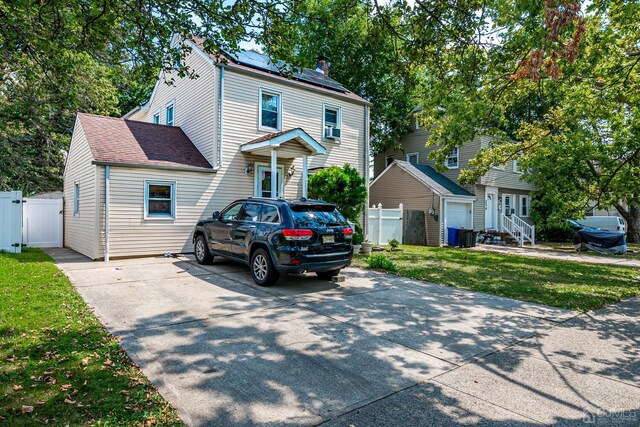 view of front of property with a front yard and solar panels