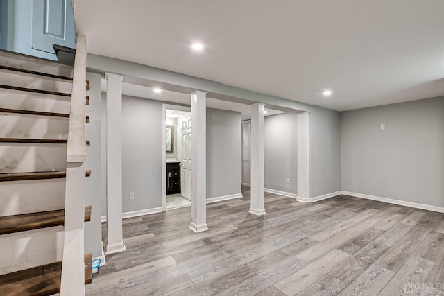 finished basement with recessed lighting, baseboards, and wood finished floors