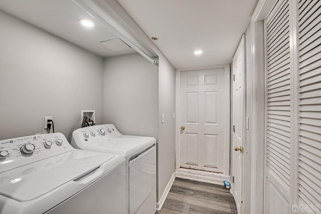 washroom featuring separate washer and dryer and hardwood / wood-style flooring