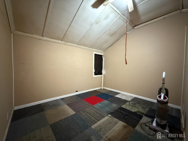 unfurnished room with lofted ceiling and baseboards