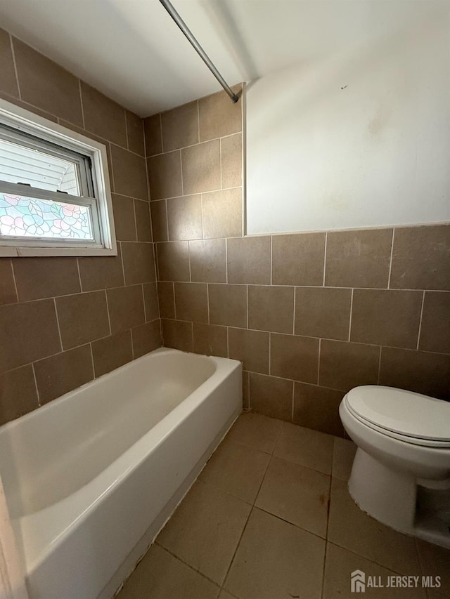 full bathroom featuring a shower, tile walls, toilet, a bathing tub, and tile patterned flooring