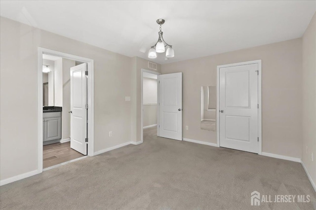 905 Chalmers Ln, Monroe, NJ 08831 - unfurnished bedroom featuring carpet, a chandelier, and connected bathroom
