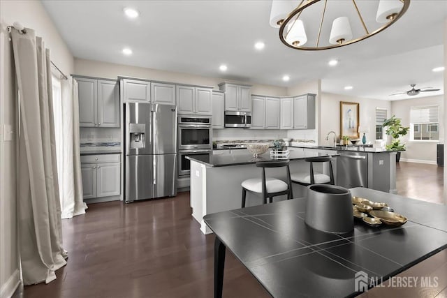 905 Chalmers Ln, Monroe, NJ 08831 - dining room featuring recessed lighting, a chandelier, dark wood-style flooring, and ceiling fan