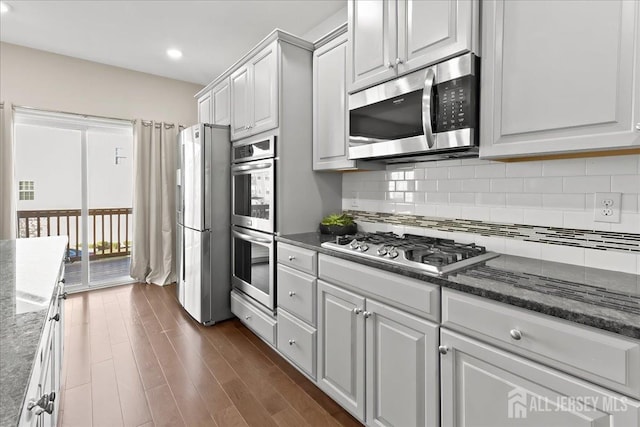 905 Chalmers Ln, Monroe, NJ 08831 - kitchen with appliances with stainless steel finishes, decorative backsplash, white cabinets, dark wood finished floors, and recessed lighting