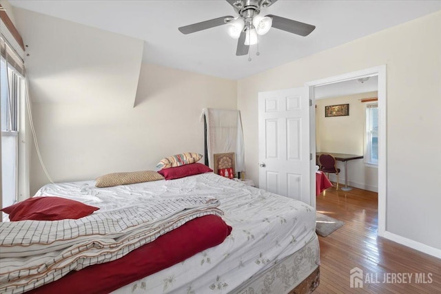 bedroom with ceiling fan and hardwood / wood-style floors