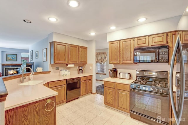 97 Fairway Blvd, Monroe, NJ 08831 - kitchen featuring black appliances, a peninsula, a tile fireplace, light countertops, and light tile patterned floors