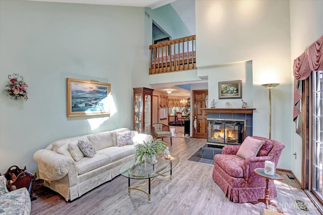 97 Fairway Blvd, Monroe, NJ 08831 - living room featuring wood finished floors, high vaulted ceiling, and a tiled fireplace