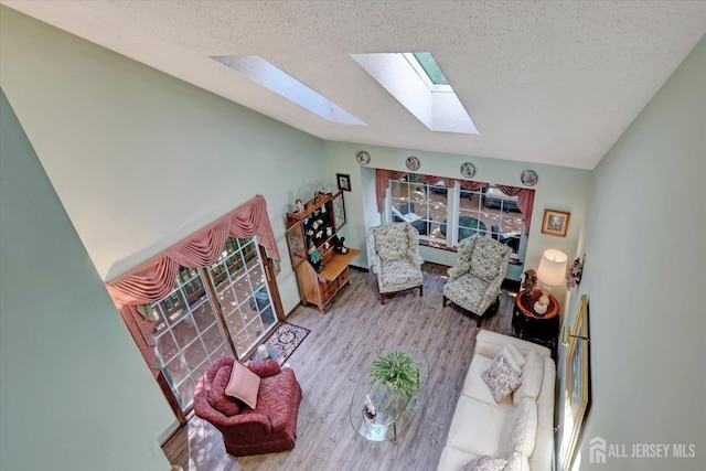 97 Fairway Blvd, Monroe, NJ 08831 - living room featuring a skylight, vaulted ceiling, wood finished floors, a textured ceiling, and healthy amount of natural light