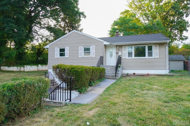 66 Willow Ave, Iselin, NJ 08830 - view of front facade featuring a front yard and a chimney