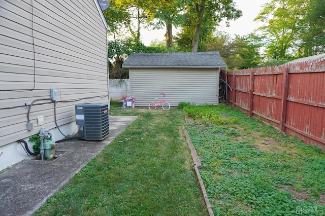 view of yard with central air condition unit and a storage unit