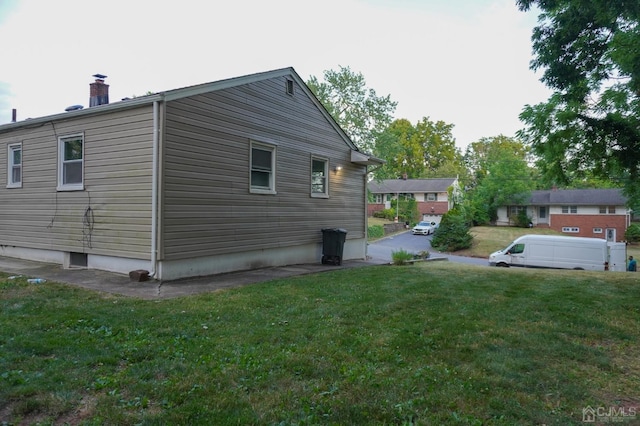 view of side of property with a yard