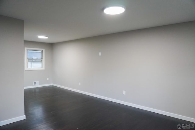 empty room featuring dark hardwood / wood-style flooring