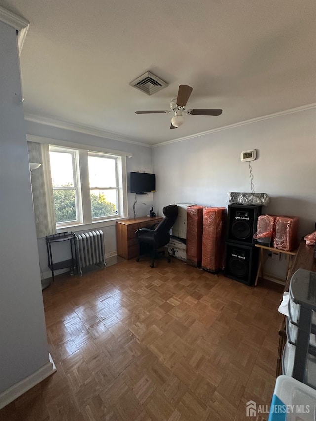 office area with visible vents, baseboards, radiator heating unit, ornamental molding, and a ceiling fan