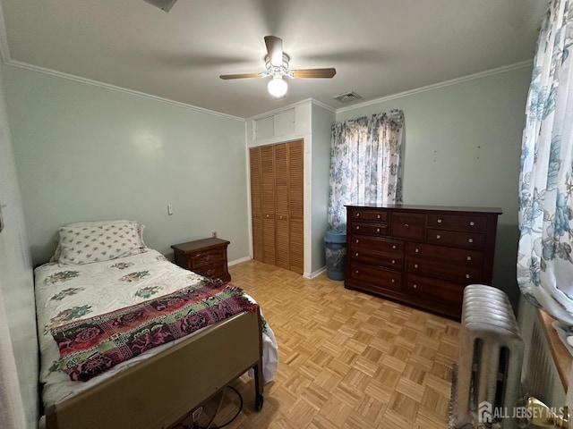 bedroom featuring visible vents, radiator, ceiling fan, ornamental molding, and a closet