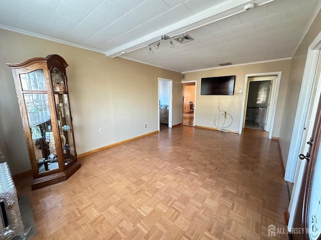 unfurnished living room with baseboards and ornamental molding