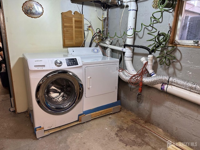 laundry room featuring separate washer and dryer and laundry area