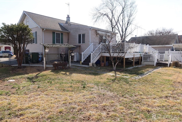 back of house featuring a deck, a patio, a yard, and fence