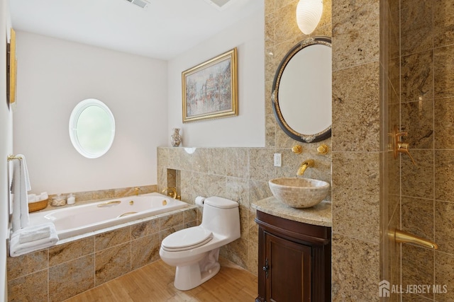 27 Mare Haven Ct, North Brunswick, NJ 08902 - full bath with wood finished floors, vanity, a garden tub, tile walls, and a tile shower
