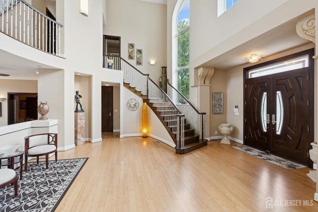 27 Mare Haven Ct, North Brunswick, NJ 08902 - foyer featuring a towering ceiling, stairway, and wood finished floors