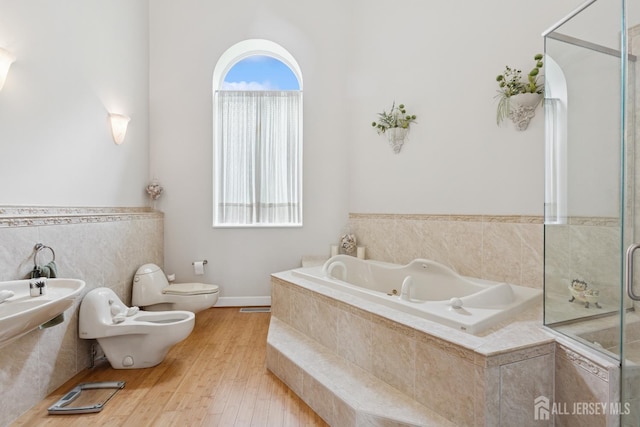 27 Mare Haven Ct, North Brunswick, NJ 08902 - bathroom featuring a bidet, a garden tub, wood finished floors, and a shower with door