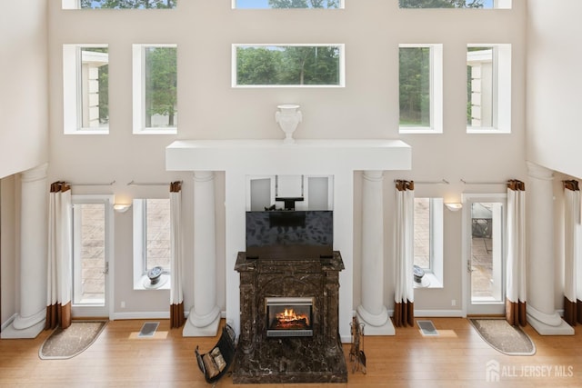 27 Mare Haven Ct, North Brunswick, NJ 08902 - living room featuring a high ceiling, a fireplace, wood finished floors, and healthy amount of natural light