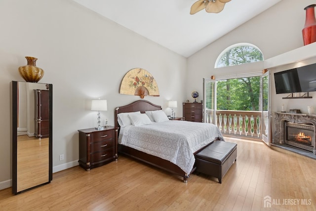 27 Mare Haven Ct, North Brunswick, NJ 08902 - bedroom featuring high vaulted ceiling, access to exterior, light wood finished floors, a premium fireplace, and ceiling fan