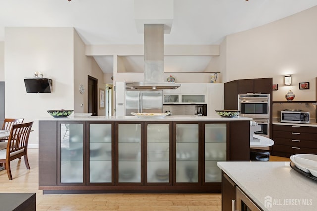 27 Mare Haven Ct, North Brunswick, NJ 08902 - kitchen with appliances with stainless steel finishes, light countertops, dark brown cabinets, glass insert cabinets, and modern cabinets