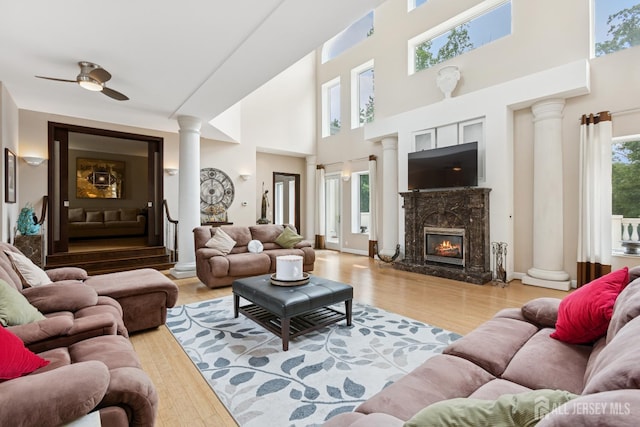 27 Mare Haven Ct, North Brunswick, NJ 08902 - living area with ornate columns, a high ceiling, wood finished floors, a fireplace, and ceiling fan