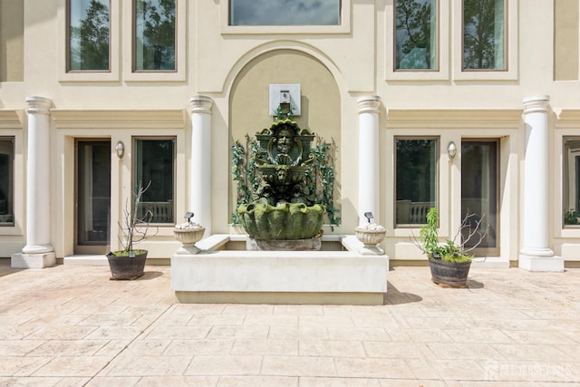 27 Mare Haven Ct, North Brunswick, NJ 08902 - view of exterior entry with stucco siding and a patio