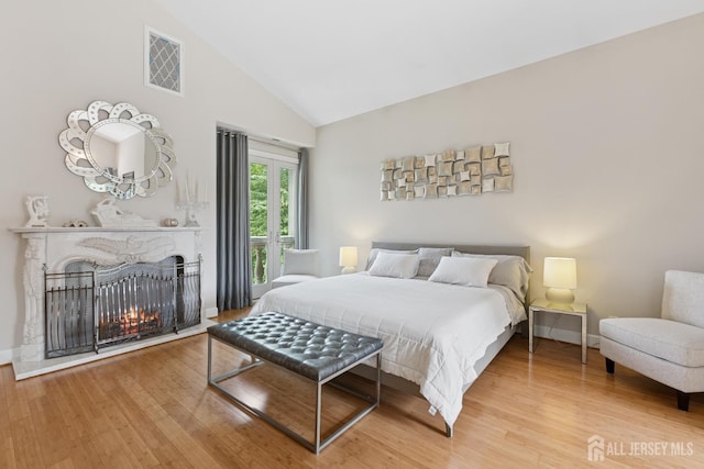 27 Mare Haven Ct, North Brunswick, NJ 08902 - bedroom with wood finished floors, high vaulted ceiling, and a multi sided fireplace
