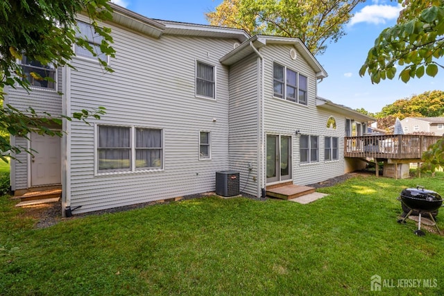 53 Rath Ln, East Brunswick, NJ 08816 - back of property with a deck, a lawn, and a fire pit