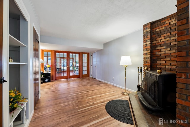 53 Rath Ln, East Brunswick, NJ 08816 - living area featuring french doors, wood finished floors, and a wood stove