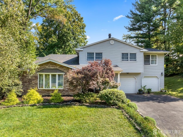 53 Rath Ln, East Brunswick, NJ 08816 - view of front of house featuring asphalt driveway, a front yard, and a garage