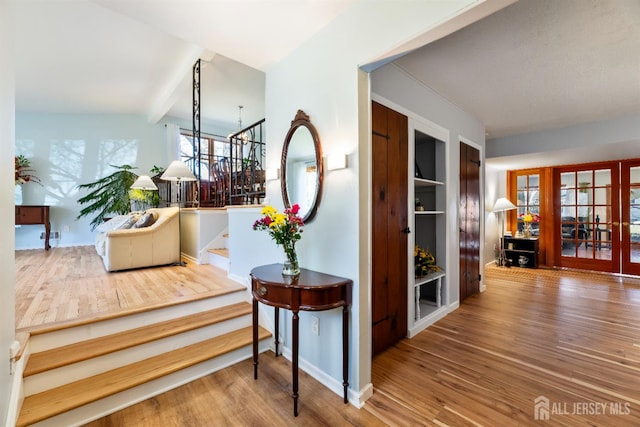 53 Rath Ln, East Brunswick, NJ 08816 - stairway featuring wood finished floors, french doors, and beam ceiling