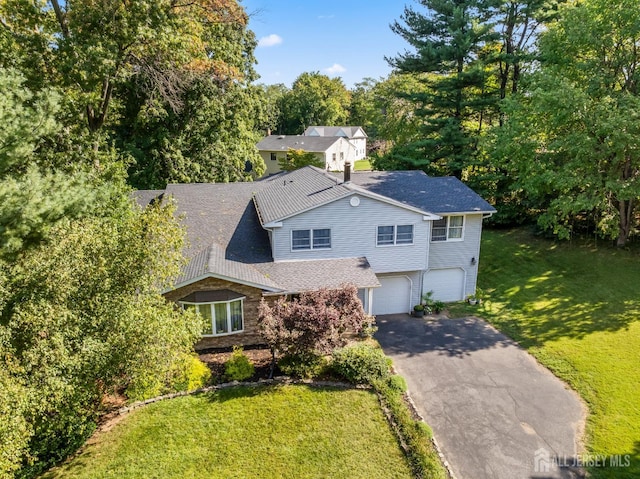 53 Rath Ln, East Brunswick, NJ 08816 - view of front of house with driveway, a garage, a front yard, and roof with shingles