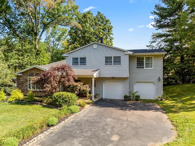 53 Rath Ln, East Brunswick, NJ 08816 - view of front of property with an attached garage, asphalt driveway, and a front lawn