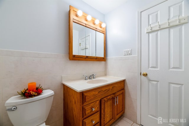 53 Rath Ln, East Brunswick, NJ 08816 - bathroom featuring tile walls, vanity, a wainscoted wall, and tile patterned flooring