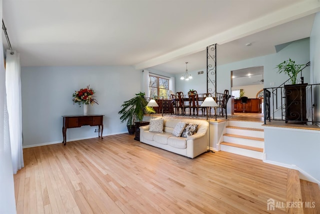 53 Rath Ln, East Brunswick, NJ 08816 - living area featuring light wood-style flooring, beam ceiling, and a chandelier