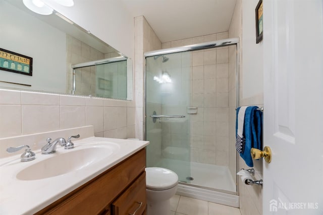 53 Rath Ln, East Brunswick, NJ 08816 - full bathroom featuring tile walls, vanity, a stall shower, and tile patterned flooring