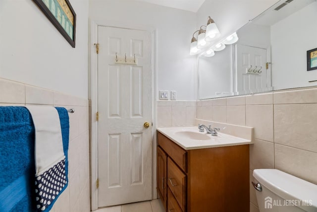 53 Rath Ln, East Brunswick, NJ 08816 - bathroom featuring tile walls, vanity, wainscoting, and tile patterned floors