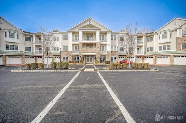 view of building exterior featuring uncovered parking and a residential view