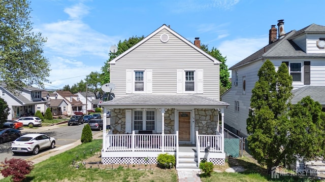 view of front facade with a porch and stone siding