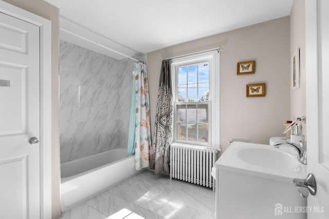 bathroom with shower / bath combo with shower curtain, marble finish floor, radiator, and vanity