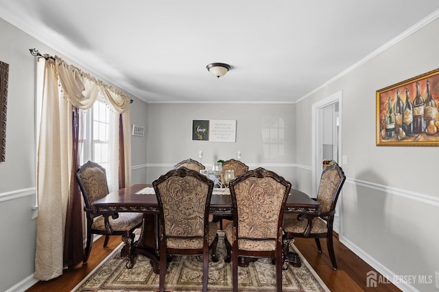 dining space with crown molding, baseboards, and dark wood-style floors