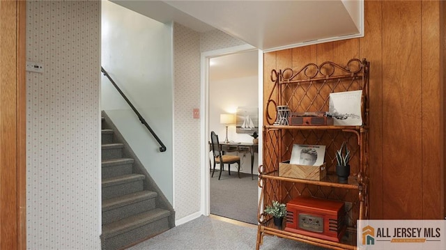 stairs with baseboards and wallpapered walls