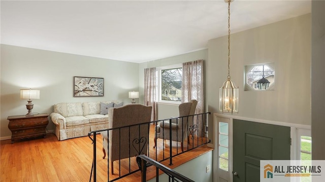 living room with plenty of natural light and wood finished floors