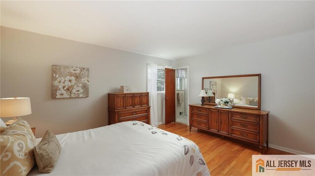bedroom featuring baseboards and light wood-style floors