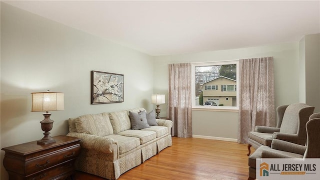 living room featuring light wood finished floors and baseboards
