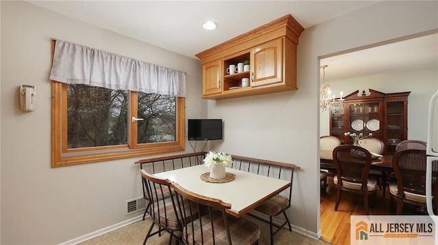 dining area featuring a chandelier, baseboards, visible vents, and recessed lighting