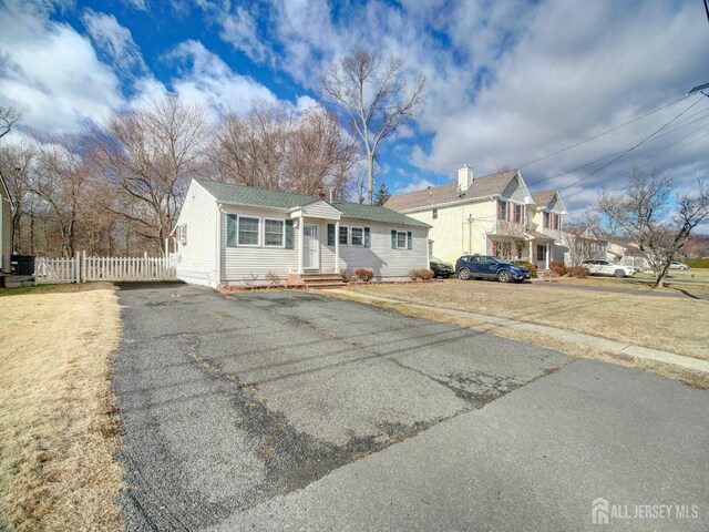 123 3rd St, Middlesex, NJ 08846 - single story home with a chimney, entry steps, and driveway